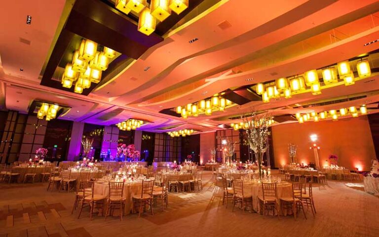 orange and red lighting ballroom with set tables at jw marriott marquis miami