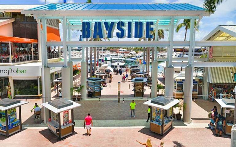 outdoor entrance to mall area with kiosks and blue glass gateway at bayside marketplace miami