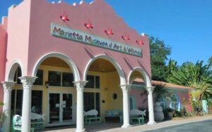pink building with arches and sign at marietta museum of art whimsy sarasota