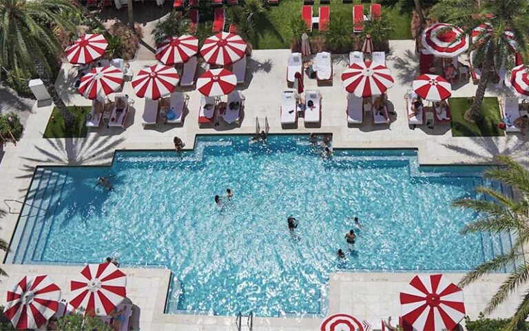 pool area view from above with red and white umbrellas at faena hotel miami beach