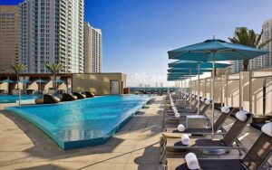 pool deck rooftop with blue and brown chaise and accents at kimpton epic hotel miami