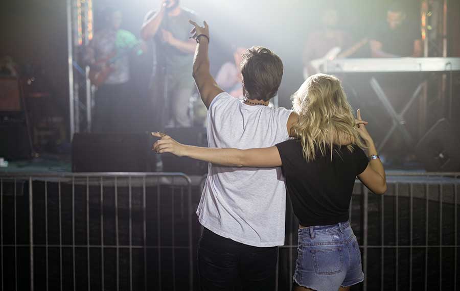 rear view of couple enjoying music concert