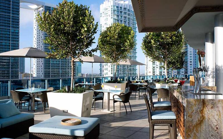 rooftop bar and dining area with skyscrapers at kimpton epic hotel miami