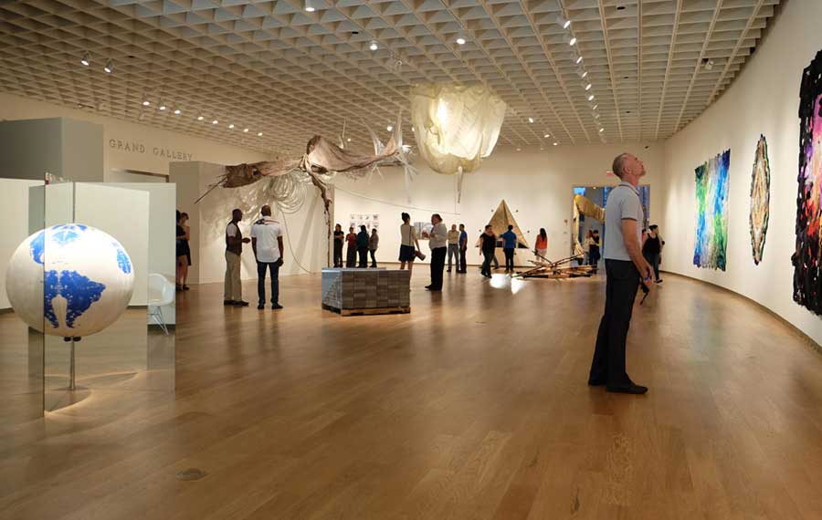 rounded room exhibit space with people viewing art at orlando art museum