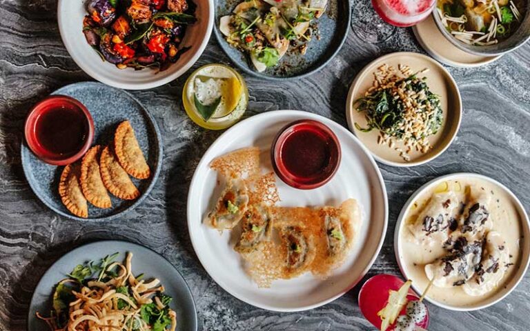 spread of asian fusion entrees at planta queen restaurant at cocowalk miami