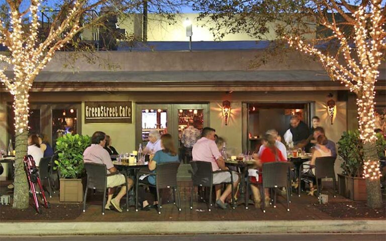 street level exterior at night with patio dining and tree lights at greenstreet cafe miami