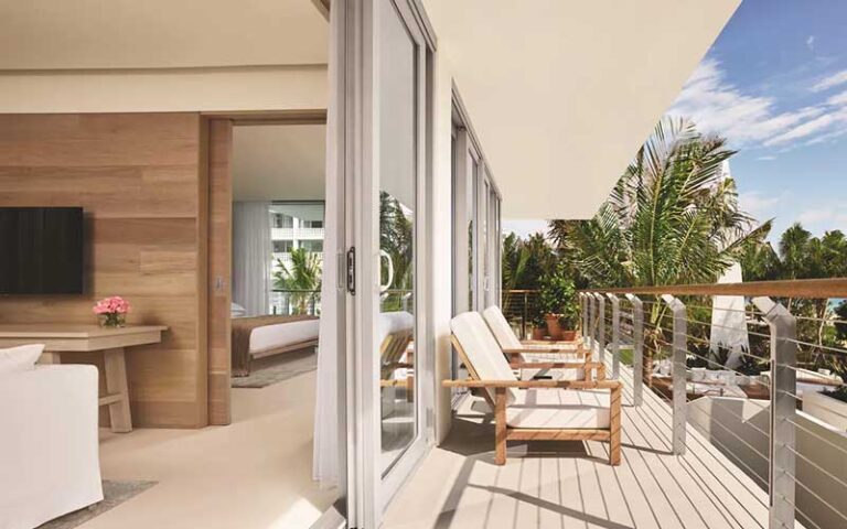 suite with patio doors beds and breezy balcony at the miami beach edition