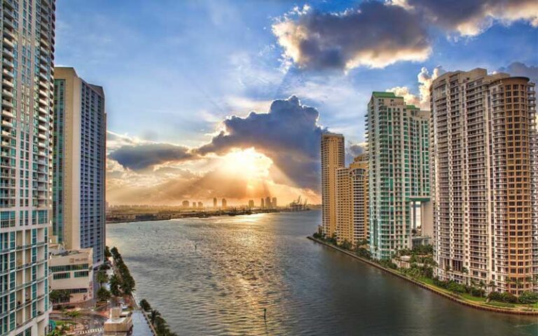 sunrise through clouds with river and bay view with high rises at kimpton epic hotel miami