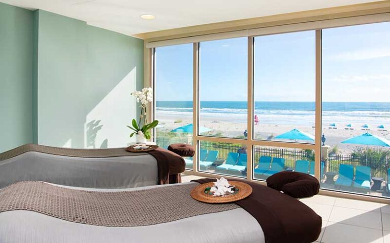 two massage beds in room with view of beach at spa at one ocean resort jacksonville