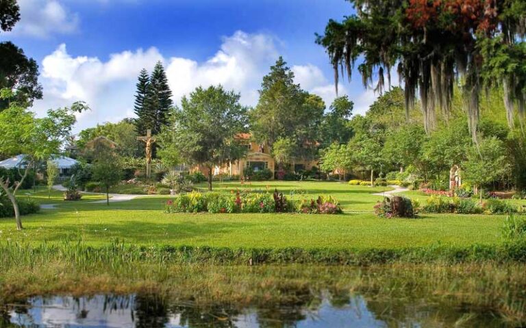 view over water of gardens with building centered at albin polasek museum orlando