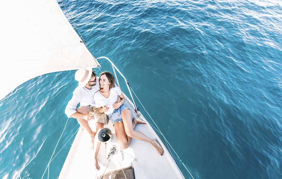 young couple relaxing on sailboat cruise