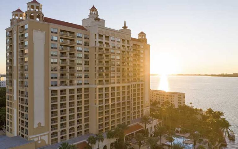 aerial exterior of hotel with pool and bay sunrise at ritz carlton sarasota