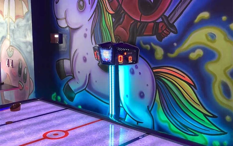air hockey table with unicorn mural at arcade monsters lido beach sarasota
