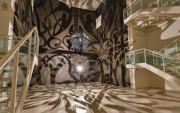 art installation with black diamond shaped lighting casting floral shadows at moca museum of contemporary art jacksonville