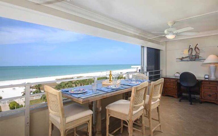 balcony area with dining seating and beach view at horizons west condo rentals sarasota