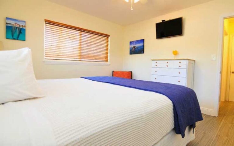 bedroom with tv bed and dresser at siesta key beachside villas sarasota