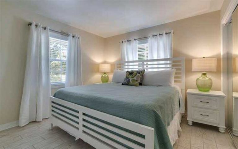 bedroom with large bed and pastel colors at cottages at siesta key sarasota