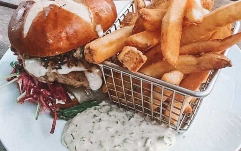 burger with fries and white sauce on plate at siegfrieds restaurant sarasota