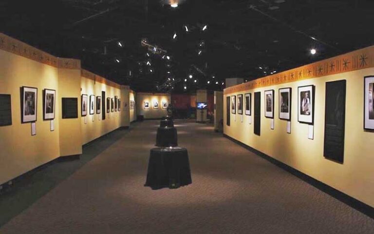 carpeted hall with hanging artwork on walls and sculpture at ritz theatre museum jacksonville