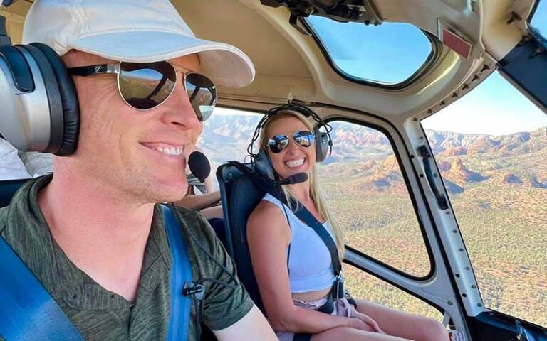 couple flying helicopter over desert at apex air helicopter tours kissimmee