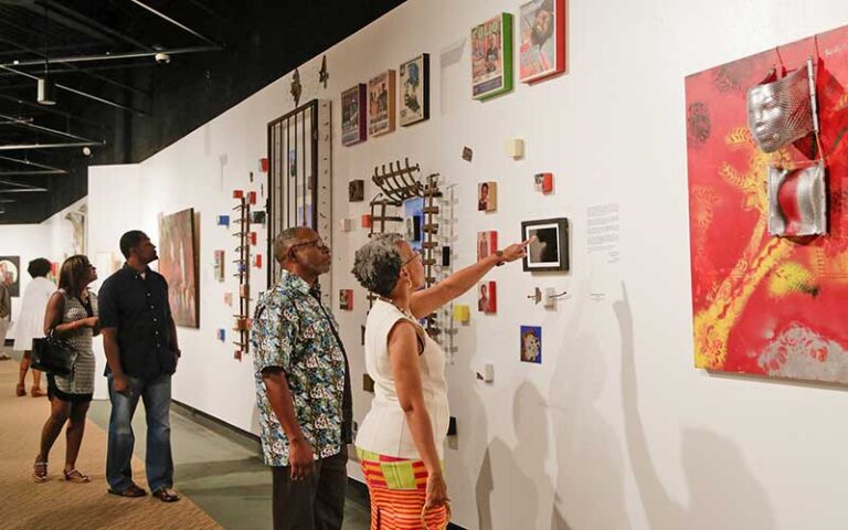 couple viewing art exhibits along wall at ritz theatre museum jacksonville