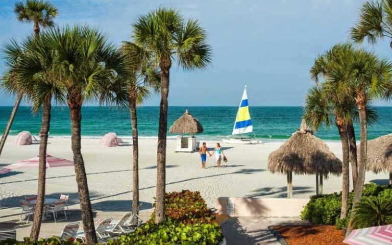 couple walking from beach to resort area at sandcastle resort lido beach sarasota