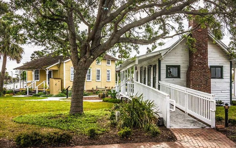 exterior of white and yellow buildings with trees at beaches museum jacksonville