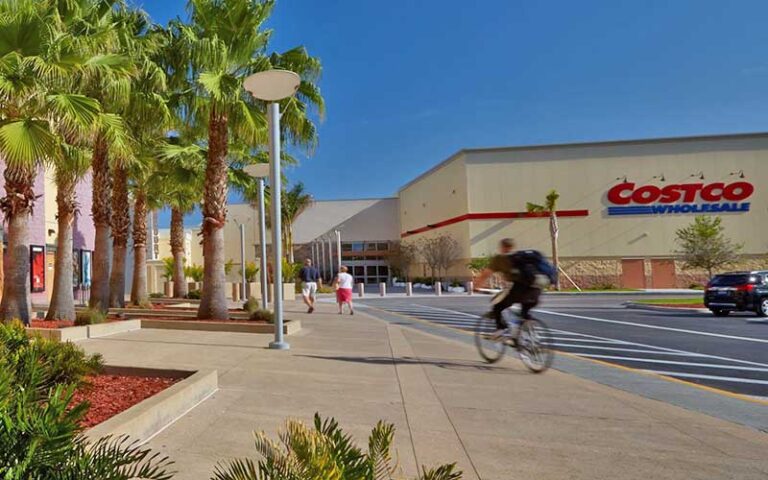 exterior side of mall with palm trees biker and costco sign at sarasota square mall