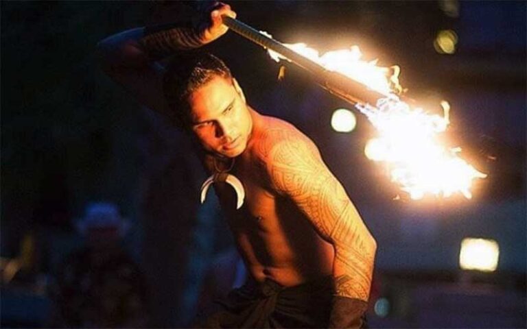 fire dancer swinging torch around back at polynesian fire luau orlando