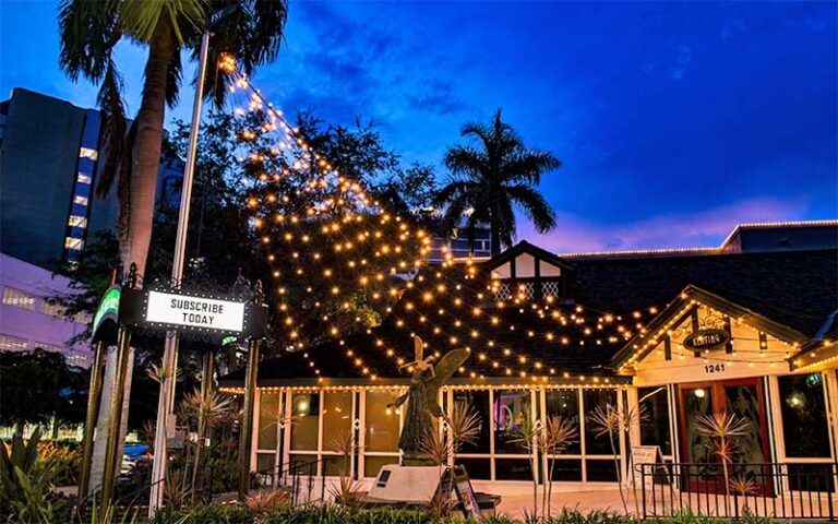 front exterior at night of theater with string lights and statue at florida studio theatre sarasota