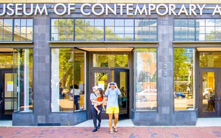 front exterior with shop windows and family emerging at moca museum of contemporary art jacksonville