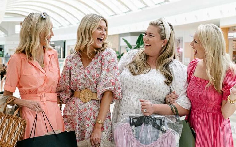 group of ladies laughing with shopping bags in mall area at mall at university town center sarasota