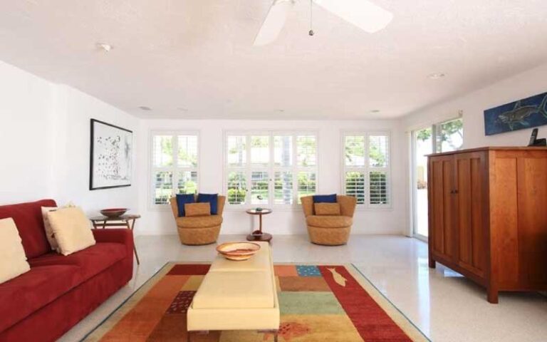 living room with red decor at horizons west condo rentals sarasota