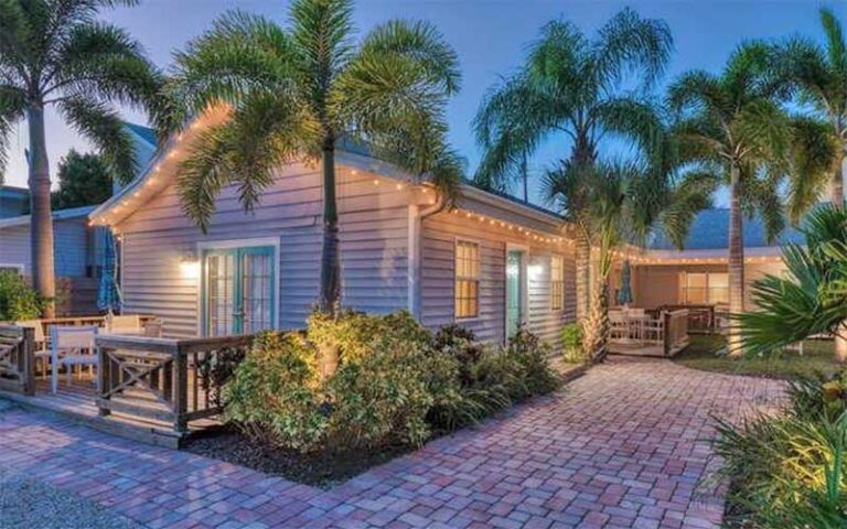 night exterior of lit up villa and trees at cottages at siesta key sarasota