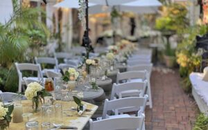 patio with long row of set tables as formal dining at garden room cafe at shoogie boogies sarasota