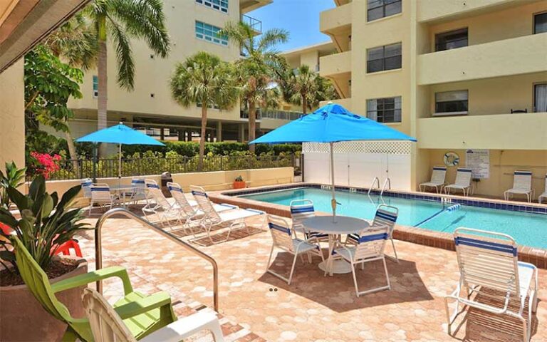 pool area with chairs at sea shell condominium sarasota