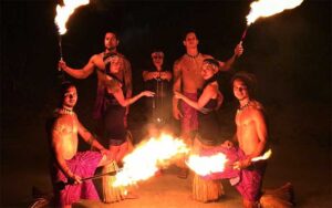 several fire performers with torches posing at polynesian fire luau orlando