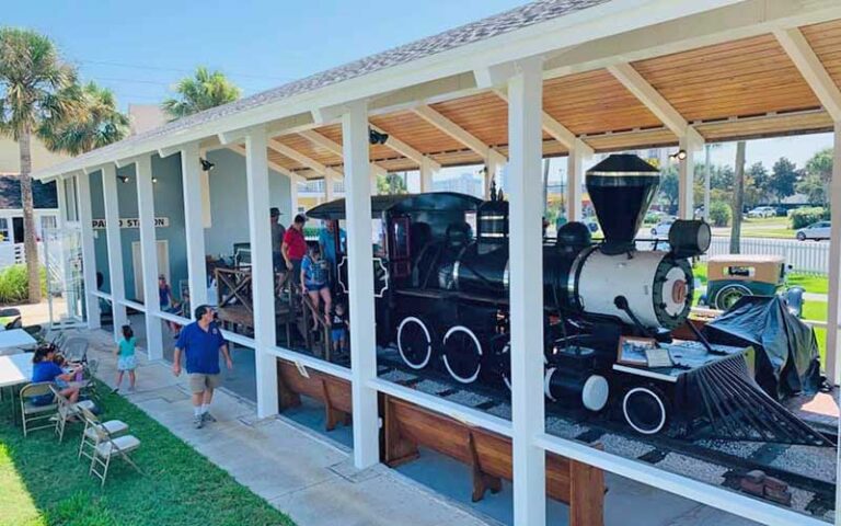 steam train exhibit in covered structure with admirers at beaches museum jacksonville