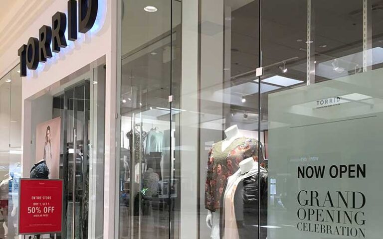 storefront of torrid with grand opening sign at sarasota square mall