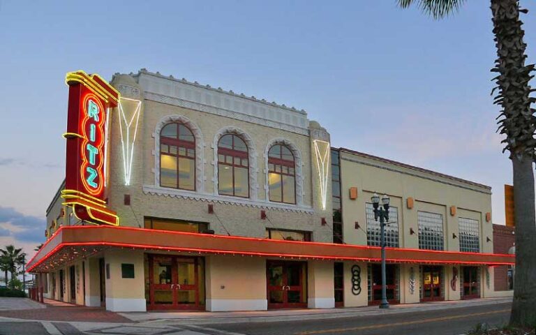 street corner exterior at dusk with theater marquee lit up at ritz theatre museum jacksonville
