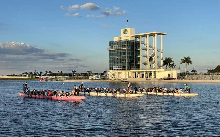 three crew boats on water with tower at nathan benderson park sarasota