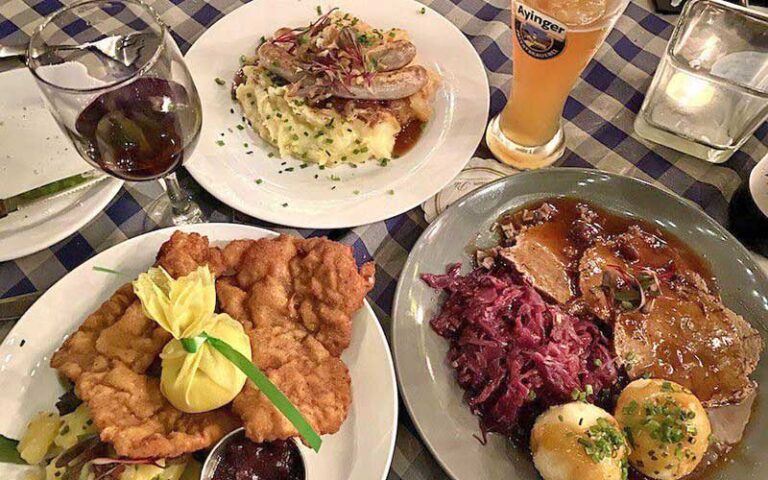 three entrees on table with beer and wine at siegfrieds restaurant sarasota