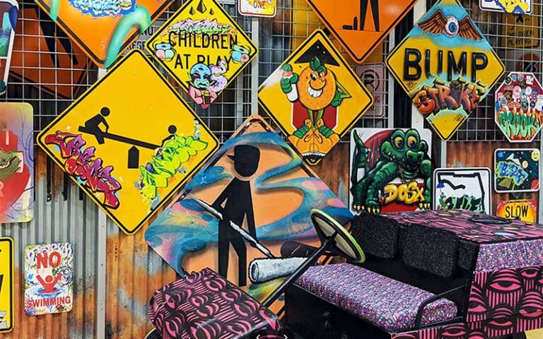 wall covered in signs and graffiti style art at young at art museum ft lauderdale