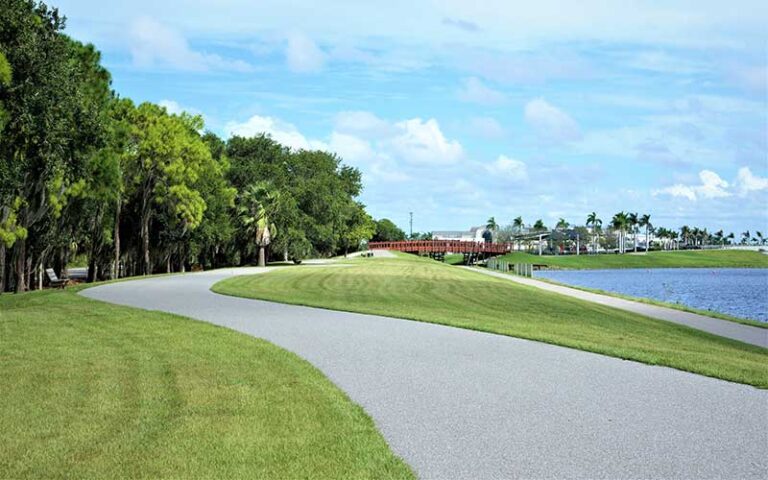 winding walkway with lake on right and bridge at nathan benderson park sarasota