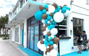 front exterior with blue and brown balloons and pickup window with patrons at nanou sunrise blvd ft lauderdale