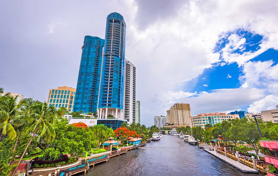 new river view from bridge of riverwalk park boats and glass skyscraper ft lauderdale