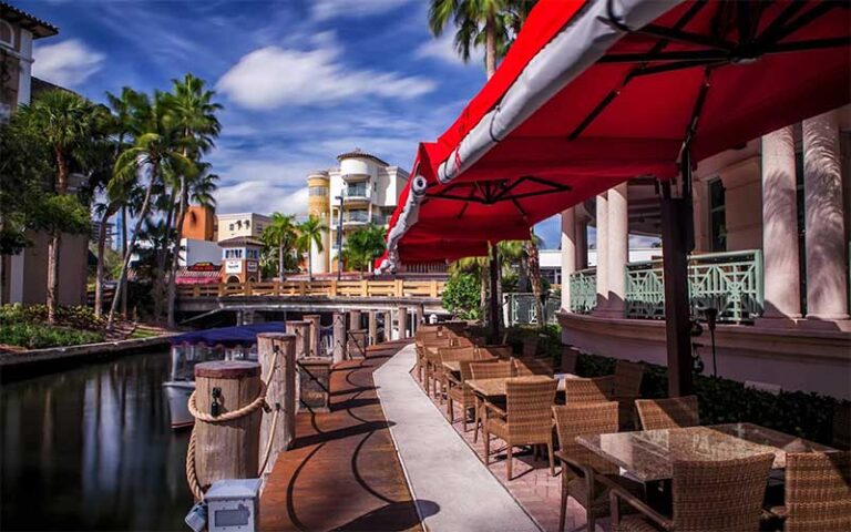 patio view along canal with dining seating and shade at casa sensei ft lauderdale