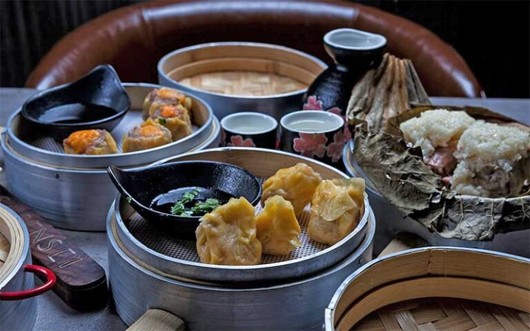 table top spread of dim sum and sake at casa sensei ft lauderdale