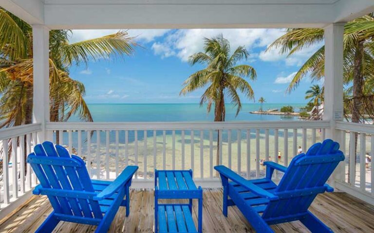 beach view from porch with blue chairs at tranquility bay beachfront resort marathon fl keys