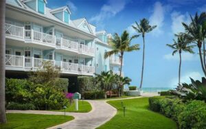 blue hotel building along beach walkway with landscaping at southernmost beach resort key west